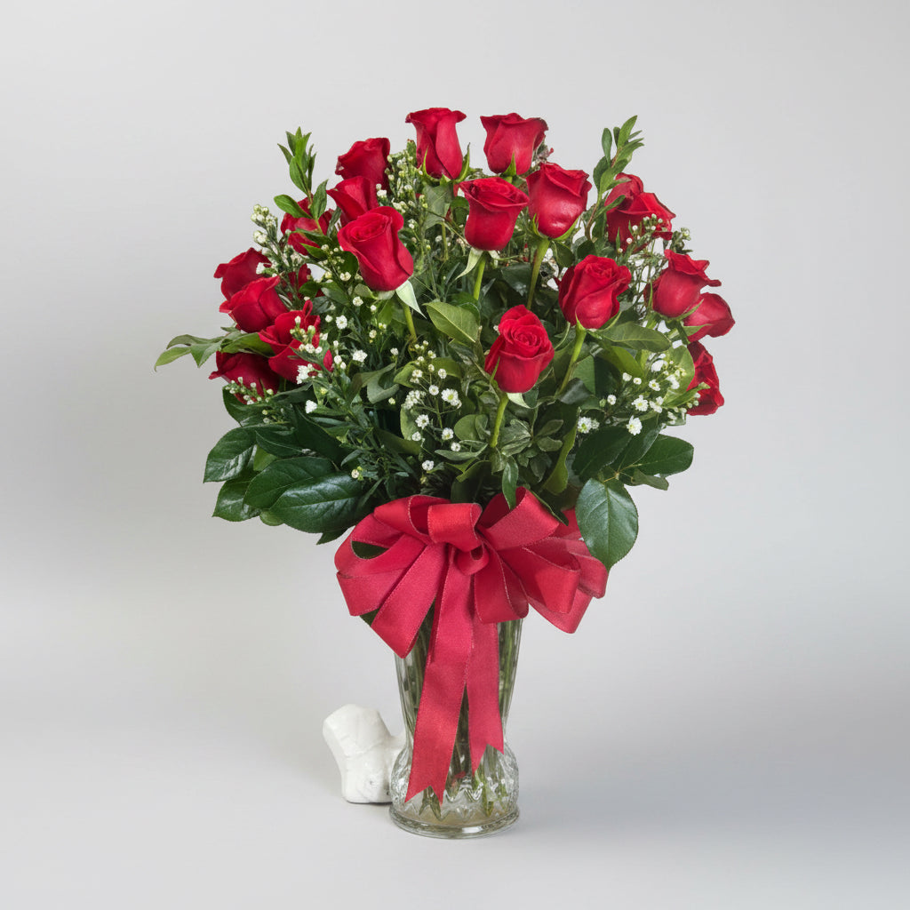 A bouquet of 2 dozen red roses, white filler and greenery.